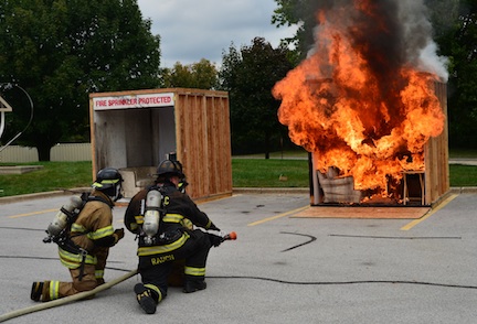 Side-by-side fire and sprinkler burn demonstration at Moraine Valley Community College during Fire Prevention Month 2016.
