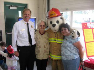 Chief Les Wedge with Sparky and guests at an open house.